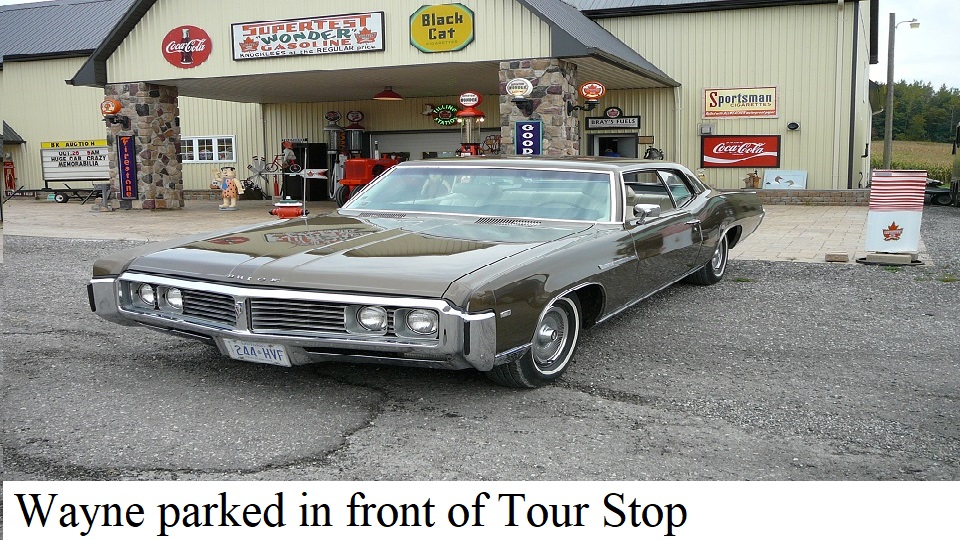 69 Buick Lesabre 400 parking in front of an impressive memorabilia collection